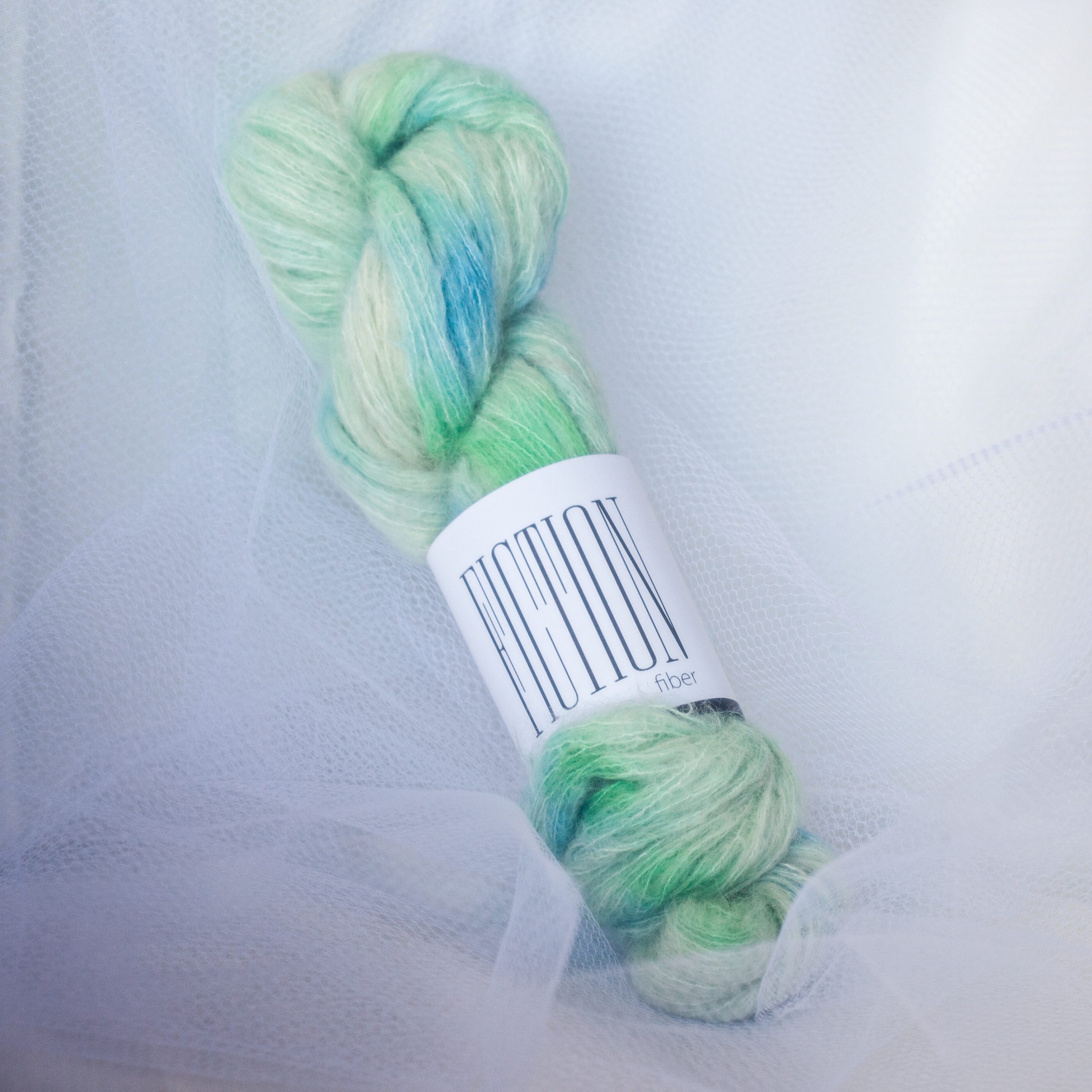 Blue green hand dyed yarn on a baby suri alpaca and silk fluffy base